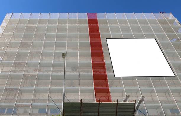 istock Blank information board on the facade under complete refurbishment to improve the energy efficiency building. 1479960776