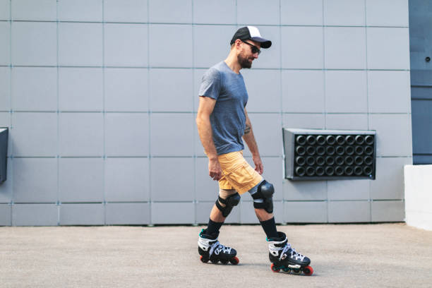 Young adult man roller skating outdoors and doing tricks