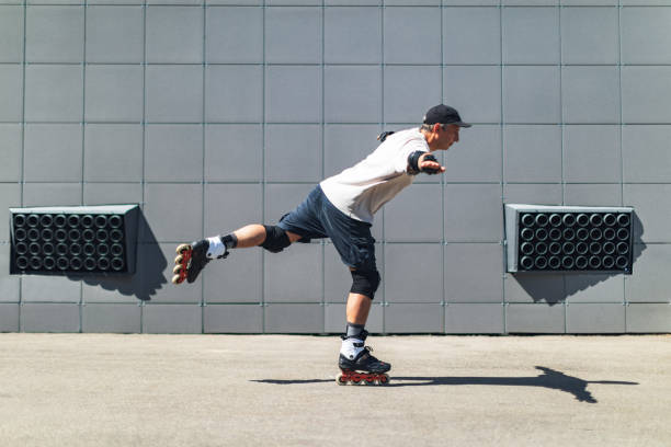 istock Young adult man roller skating outdoors and doing tricks 1479960961