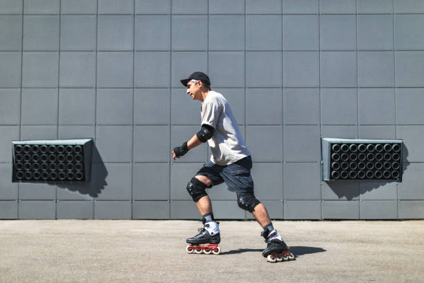 Young adult man roller skating outdoors and doing tricks