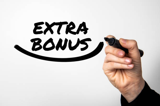 istock Extra Bonus. A hand with a marker writes text on a light background 1479963181