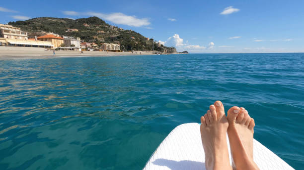istock POV of a young woman's feet on paddle board (SUP) 1479967999