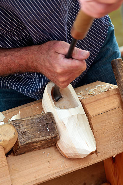 istock Farmer demonstrating the making of Dutch wooden clogs 147996856