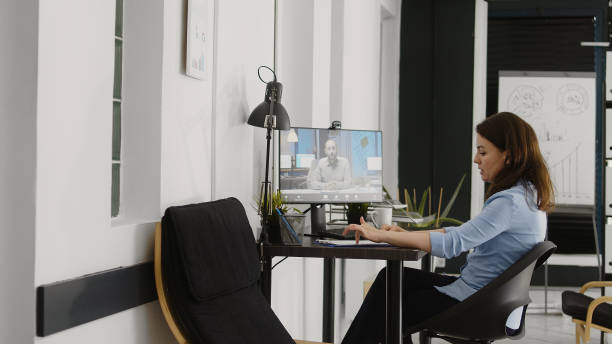 istock Female employee using videocall conference on webcam 1479970303