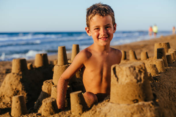 istock Boy making a sand castle on the beach 1479976951