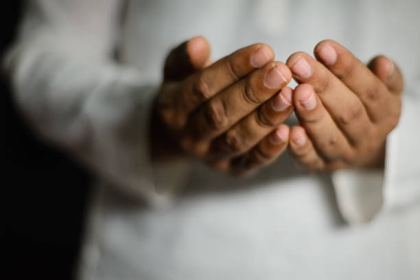 istock Muslim person making dua rising hands 1479978339