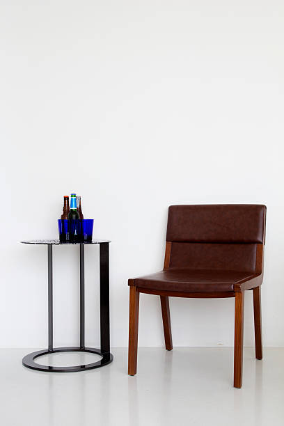 istock White wall and Leather chair with drinking on table 147997845