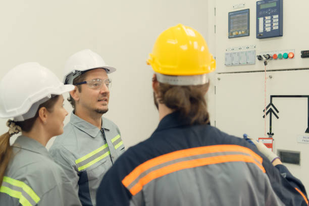 istock Electric power engineering team inspecting system of a large solar energy storage station in the middle of the field of solar cells on an area of hundreds of acres 1479978506