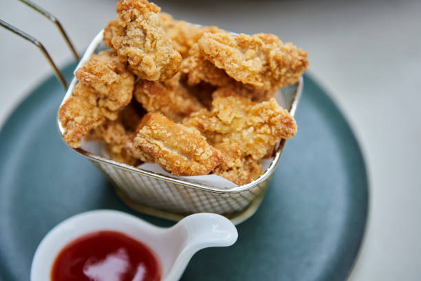 istock Crispy fried chicken in fryer basket with ketchup 1479983552