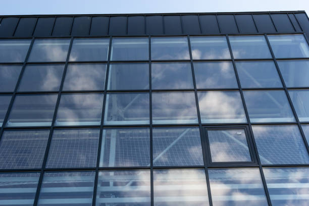 istock Bottom view of a modern skyscraper building with glass window against sky background for promotional content. Contemporary business centre with new perspective design 1479987691