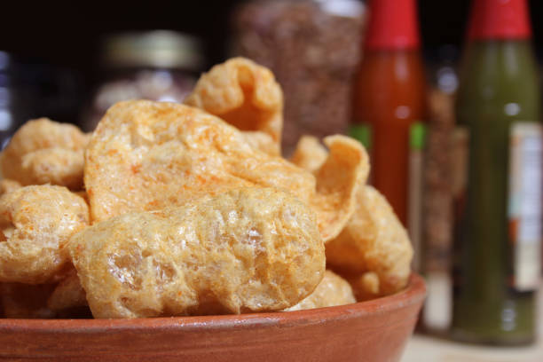 istock Fried Pork Skins With Hot Sauce in Rustic Kitchen 1479989428