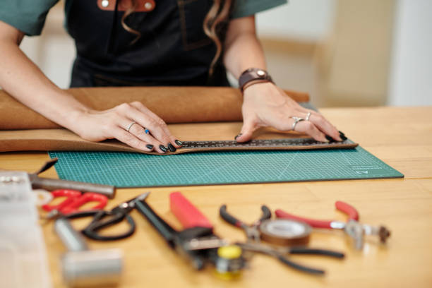 istock Woman Measuring Leather Piece 1479989520
