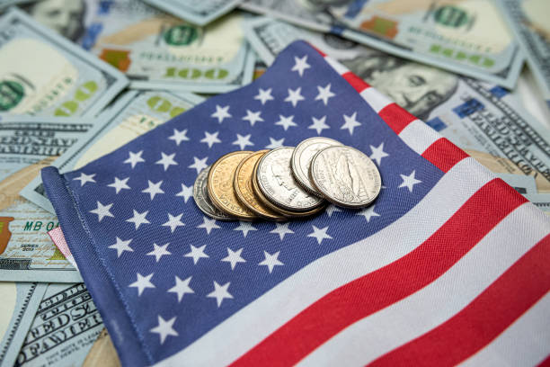 istock American flag with dollar bills banknotes and coin 1479989644