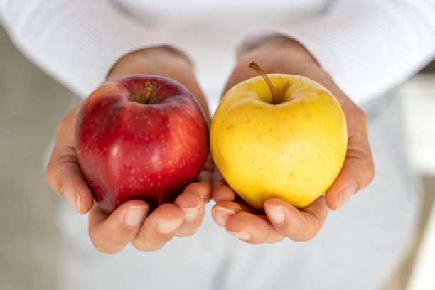 istock Red and yellow apples in human hand 1479992205