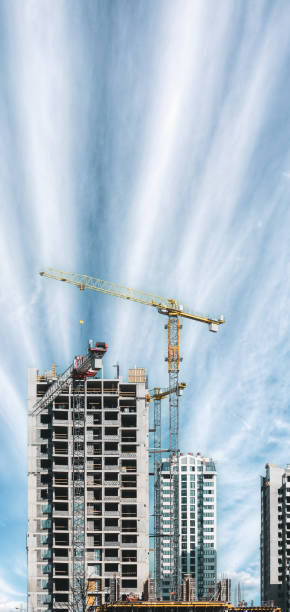 istock Amazing Bright Blue Sky Above Construction Crane. Construction And Development Of New Multi-storey Residential. Residential Houses. Conception Of Development. New Accommodation 1479992496