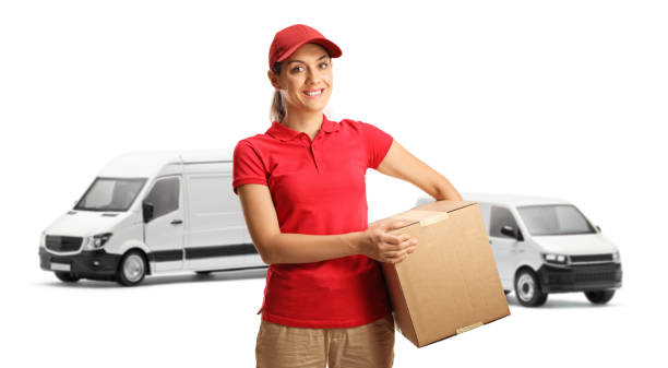 istock Female courier with a van holding a cardboard box and smiling 1479994490