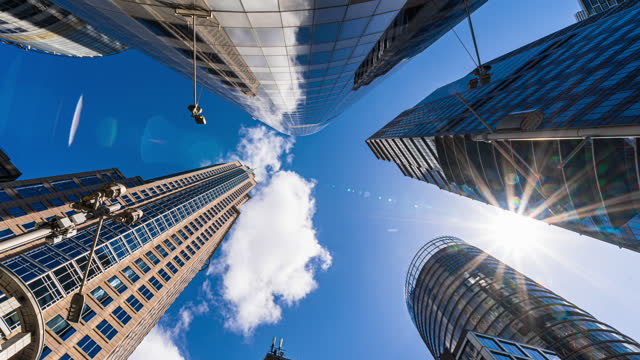 4K Footage Time lapse Low angle of tall Business buildings skyscraper with reflection with clouds among high buildings center in Central Business district of Sydney