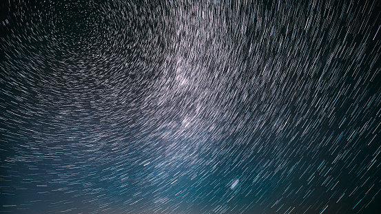 Night Starry Sky Stars And Meteoric Track Trails. Stars Rotate Of Sky Background. Spin Trails Of Stars. Large Exposure. Spin Of Stars