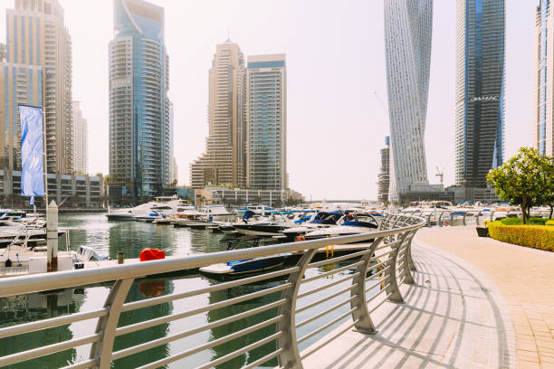 dubai marina port, uae, united arab emirates. yachts are moored at city pier, jetty in dubai marina in sunny summer day. cityscape skyline. urban background - famous place dubai marina editorial united arab emirates imagens e fotografias de stock