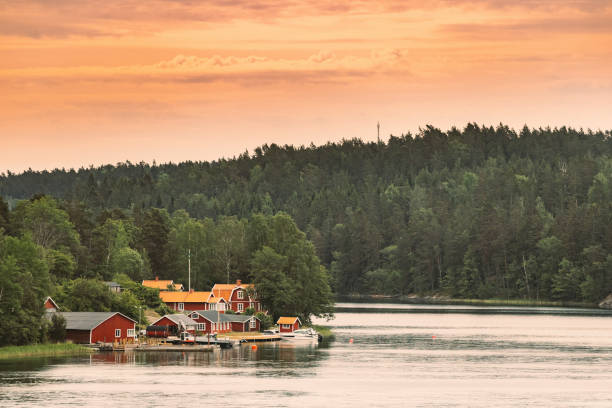 Sweden. Many Beautiful Red Swedish Wooden Log Cabins Houses On Rocky Island Coast. Lake Or River Landscape Sweden. Many Beautiful Red Swedish Wooden Log Cabins Houses On Rocky Island Coast. Lake Or River Landscape. swedish sauna stock pictures, royalty-free photos & images