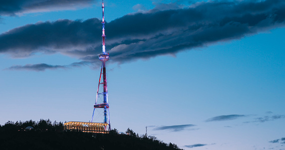 Tbilisi, Georgia. Night Scenic View Of Georgia Tbilisi Tv Broadcasting Tower. Located On Territory Of Mtatsminda Park. Tower Is 274.5 M 901 Ft High On Mountain At 719 M 2,360 Feet Above Sea Level.