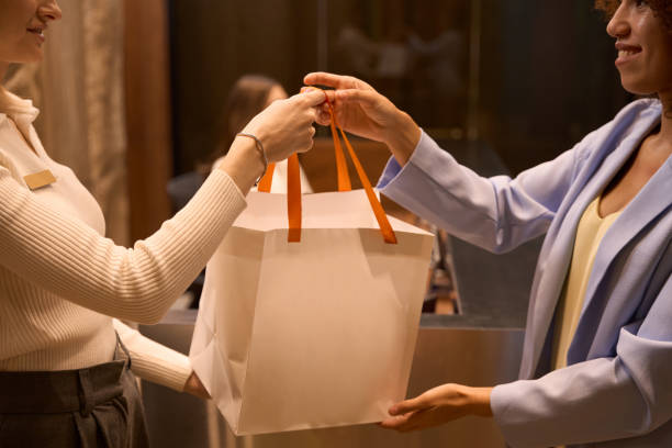 istock Female worker giving to customer package in lobby 1479997360