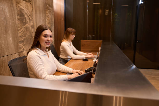 istock Pretty female employee facing camera during work at reception 1479997394