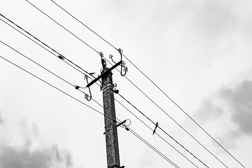 Power electric pole with line wire on light background close up, photography consisting of power electric pole with line wire under sky, line wire in power electric pole for residential buildings