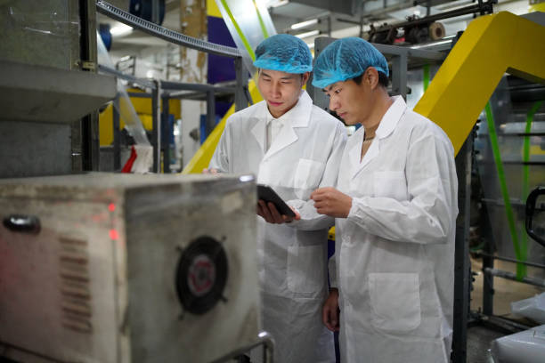 The production manager checks the production status in the workshop using a tablet