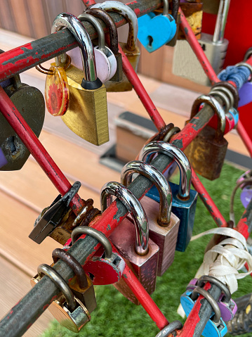 Stock photo showing close-up view of love padlocks attached to purpose built heart-shaped framework on Clarke Quay in Singapore.