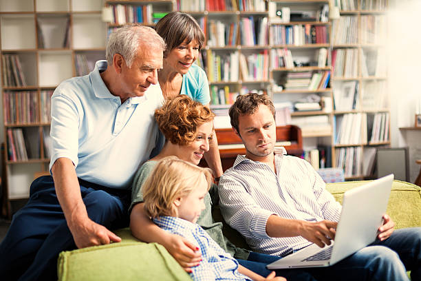 three generation family making projects together stock photo