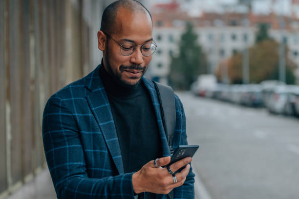 istock man looking at mobile phone in the street 1480004823