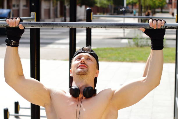 istock Man doing workout on horizontal bar on the street 1480004997