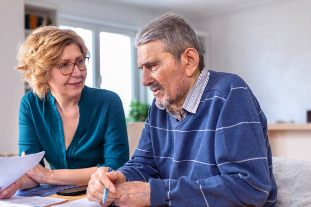 istock Woman Helping a Senior  Man With Documents And Bills 1480006399
