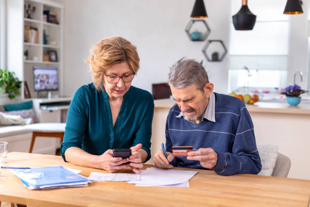 istock Woman Helping a Senior  Man With Documents And Bills 1480006405