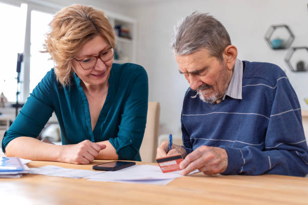 istock Woman Helping a Senior  Man With Documents And Bills 1480006435