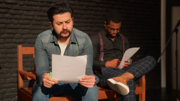 istock Male theater play performer reading and checking his text on stage 1480010576