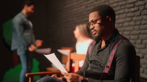 istock Male theater play performer reading and checking his text on stage 1480010654
