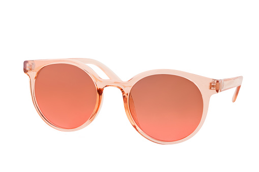 Peach colored sunglasses with plastic frame, white background, clipping path, cut out