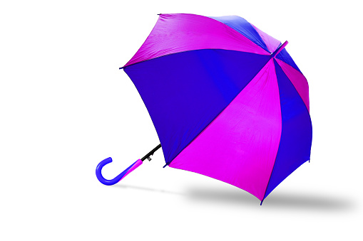 Young woman aged 25 to 30 years laughing, holding colourful umbrella