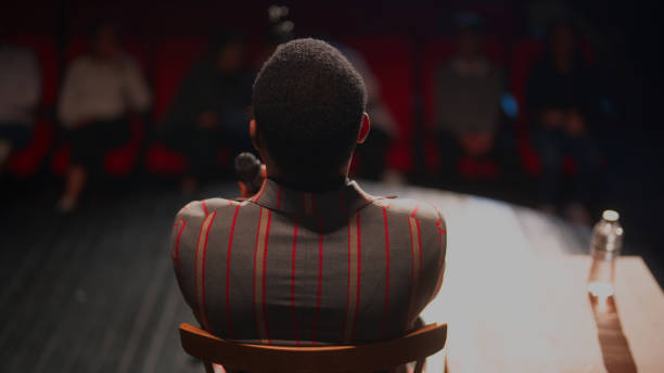 istock Black ethnic stand-up comedian talking on stage 1480015335