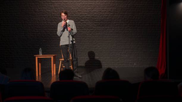 istock Male stand-up comedian talking on stage 1480015653