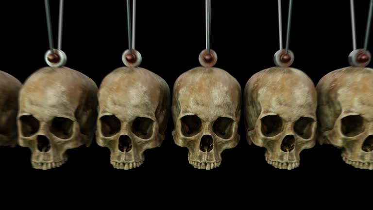 Newton's Cradle made with skulls isolated on black