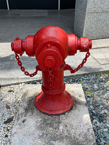 Stock photo showing close-up view of a red fire hydrant in front of an office.
