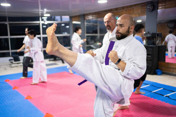 istock Mid adult man kicking during a karate class 1480016028