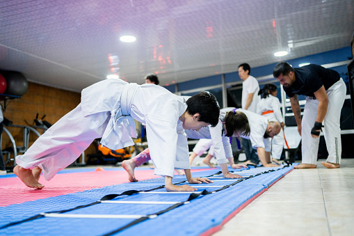 Boy doing warm up exercise on a karate class