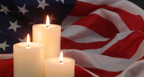 istock Burning candles on USA flag background. 1480016153
