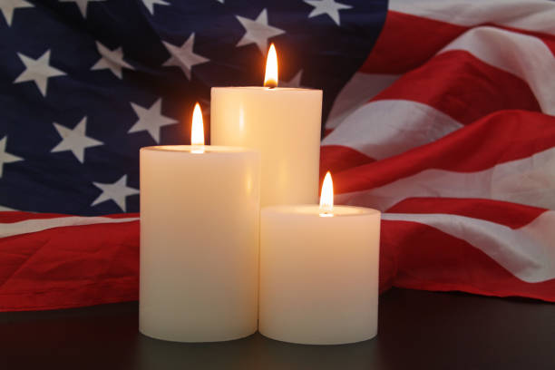 istock Burning candles on USA flag background. 1480016154