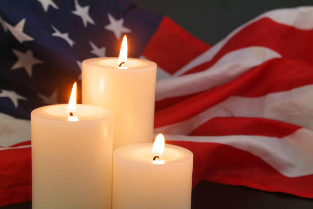 istock Burning candles on USA flag background. 1480016157