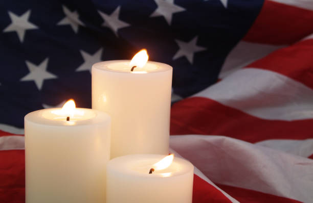 istock Burning candles on USA flag background. 1480016305